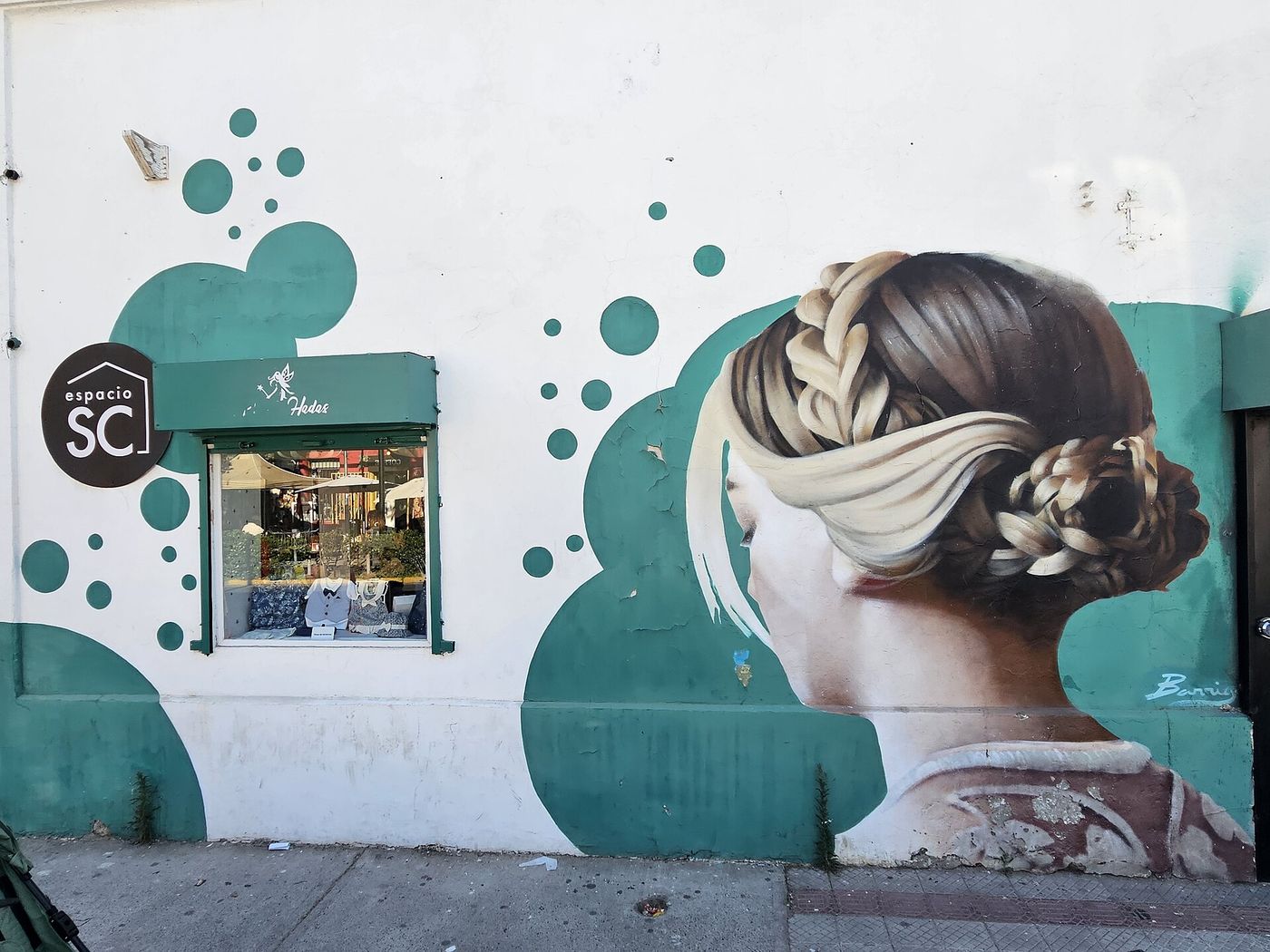 Painted mural beside a small boutique window in Barrio Italia, Santiago