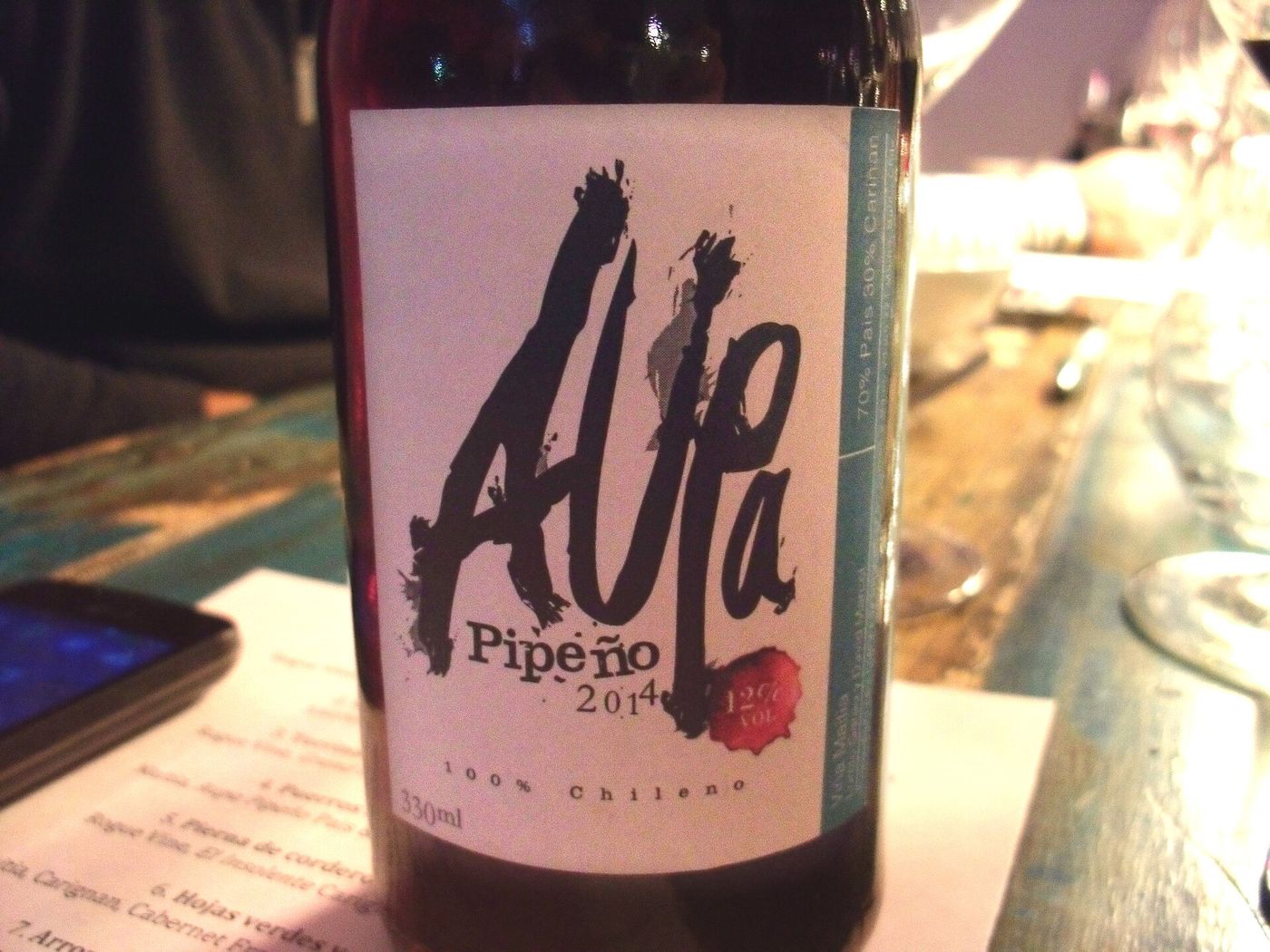 A bottle of Chilean pipeno country wine on a restaurant table