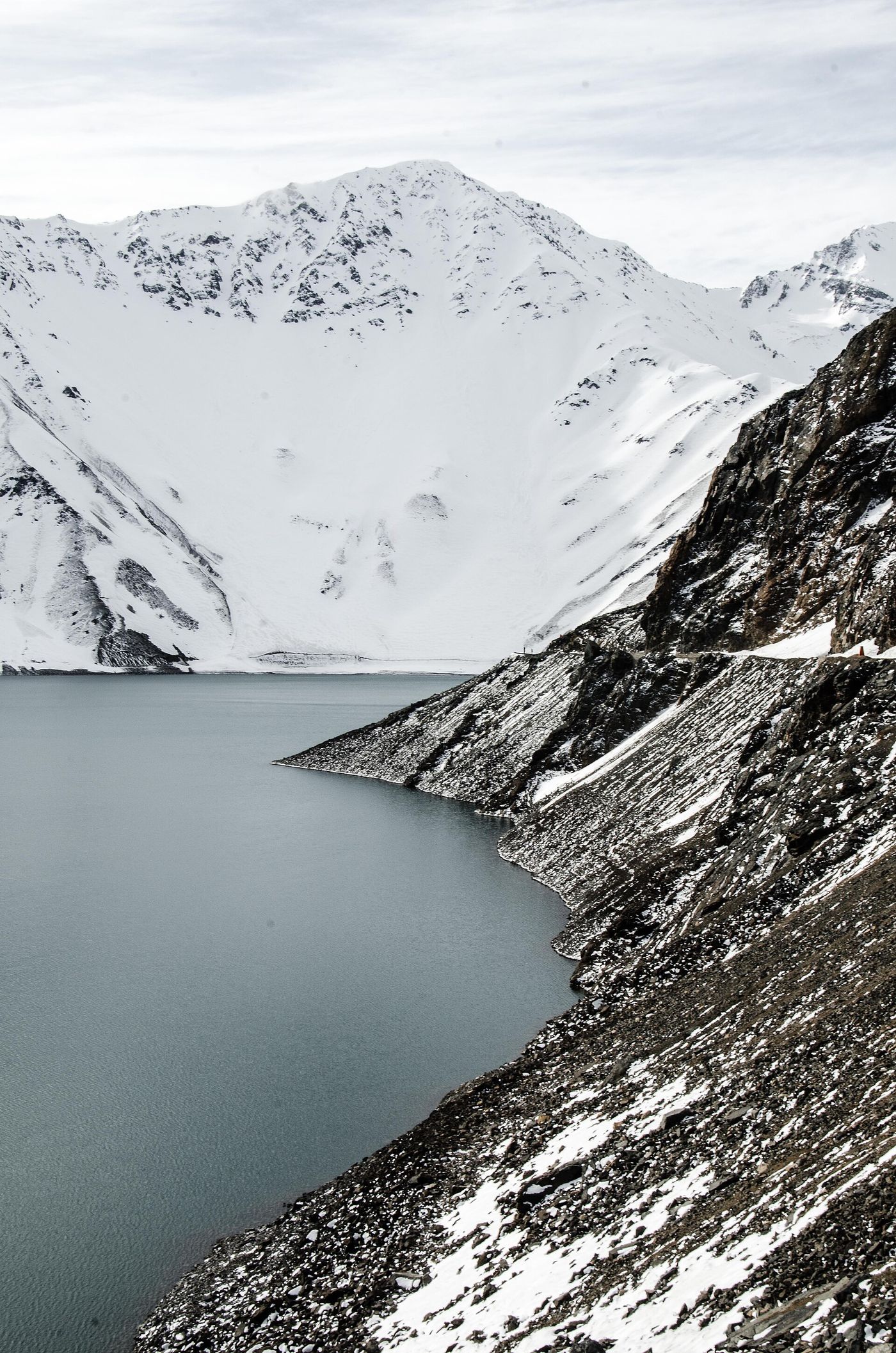 Embalse El Yeso reservoir surrounded by snow-covered Andes slopes in Cajón del Maipo