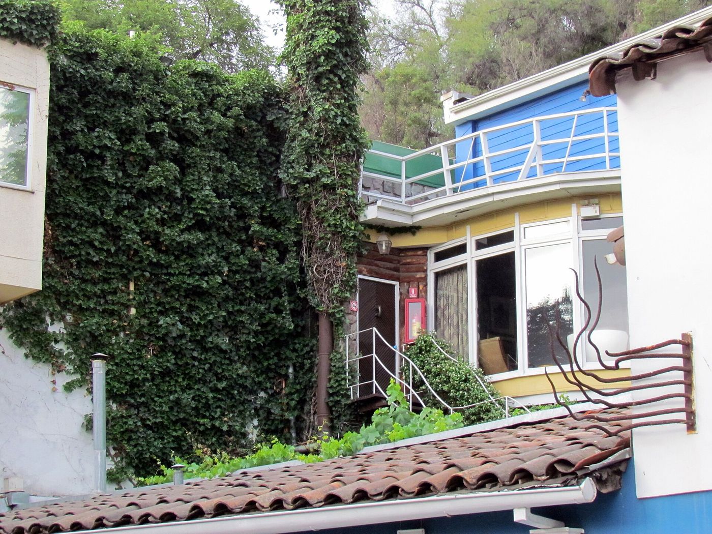 Blue walls and wooden door of La Chascona, Pablo Neruda's house in Bellavista