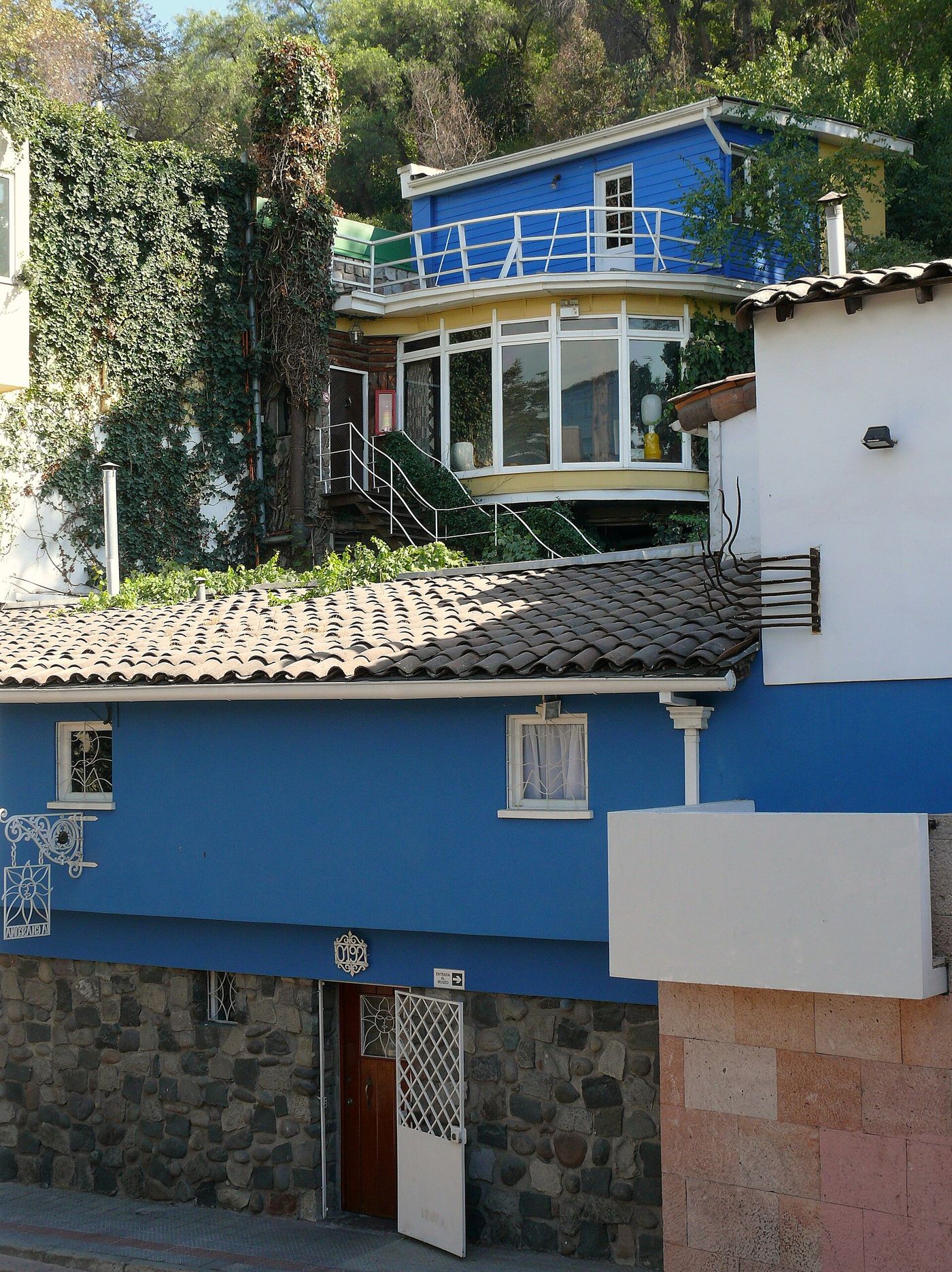 Blue-painted sections of Pablo Neruda's house La Chascona climbing a hillside in Bellavista, Santiago