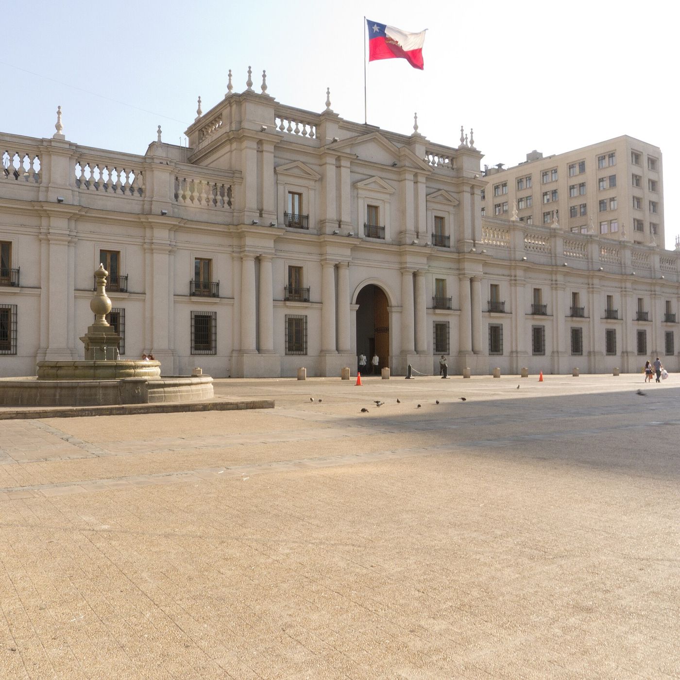 Front facade of the Palacio de La Moneda presidential palace in Santiago with the Chilean flag flying above it