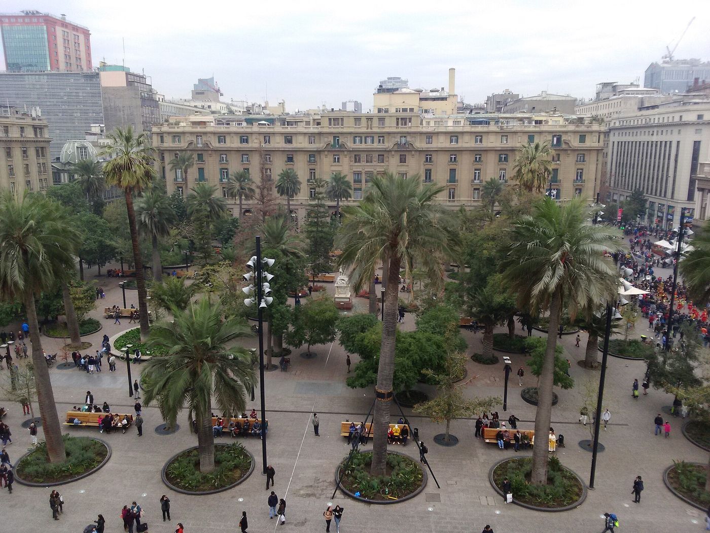Plaza de Armas in Santiago seen from above, with palm trees and people crossing the square