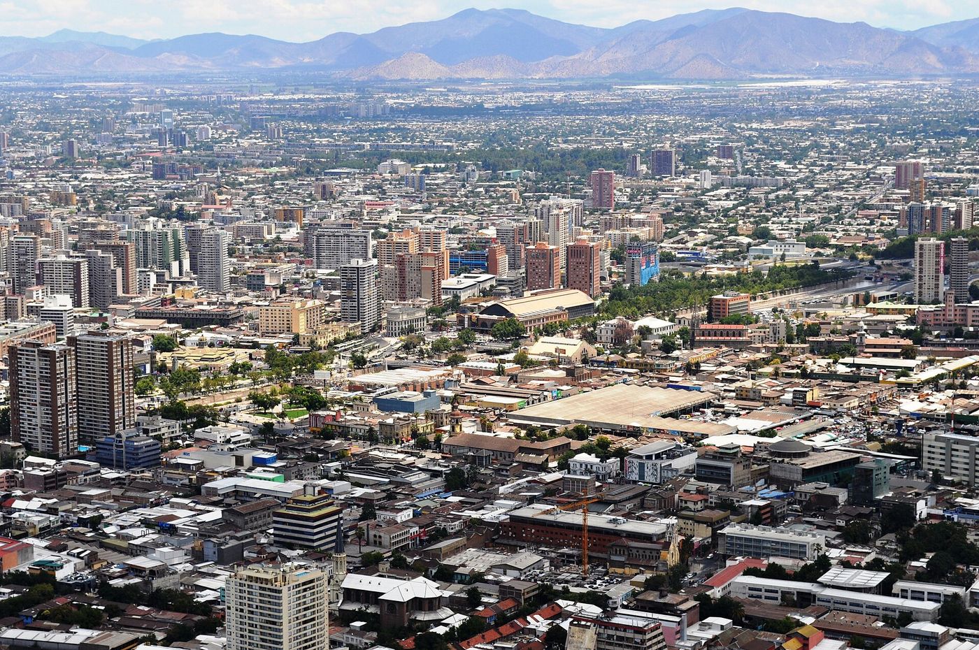 Wide view over central Santiago rooftops toward the hills on the edge of the city