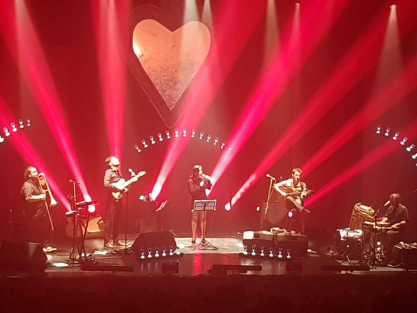 A band performing under red stage lights at the Matucana 100 cultural centre in Santiago
