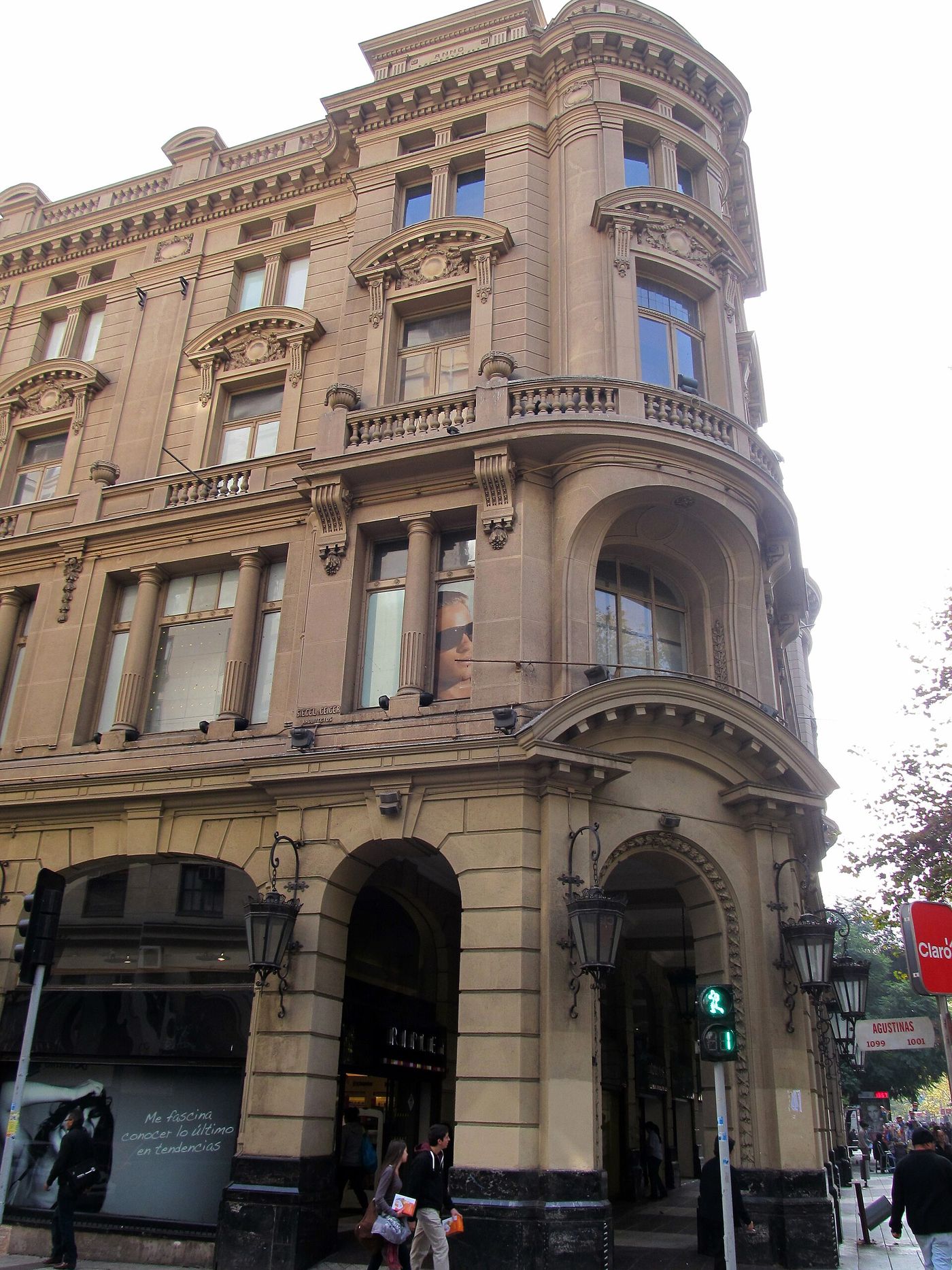 Ornate stone facade of a historic hotel building on a street corner in central Santiago
