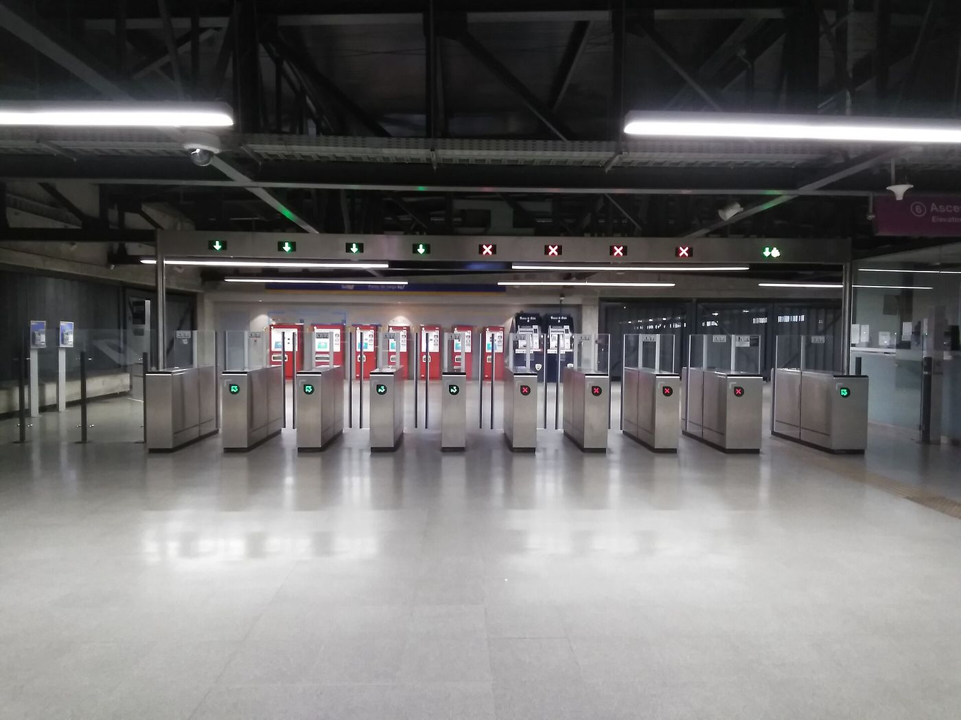 Row of ticket gates at a Santiago Metro station concourse