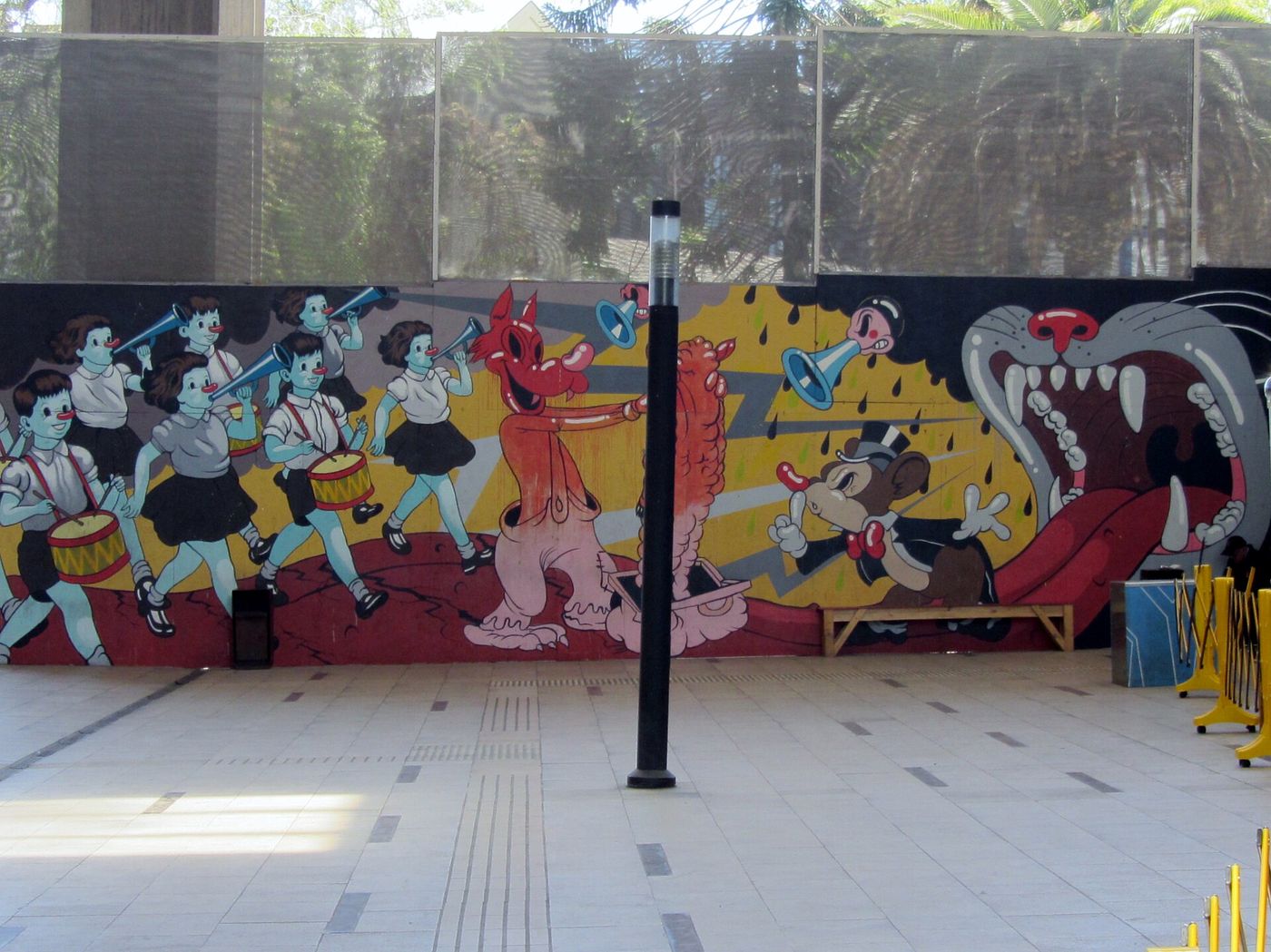 A large painted mural along the side of a public plaza at GAM in Santiago