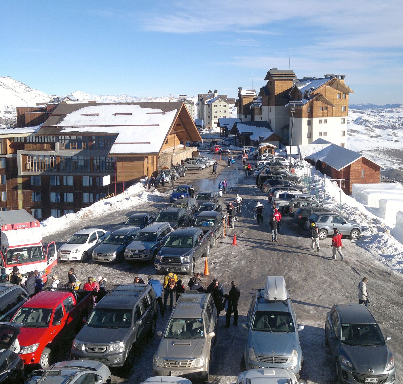 Base village buildings and parked cars in the snow at Valle Nevado ski resort, Chile