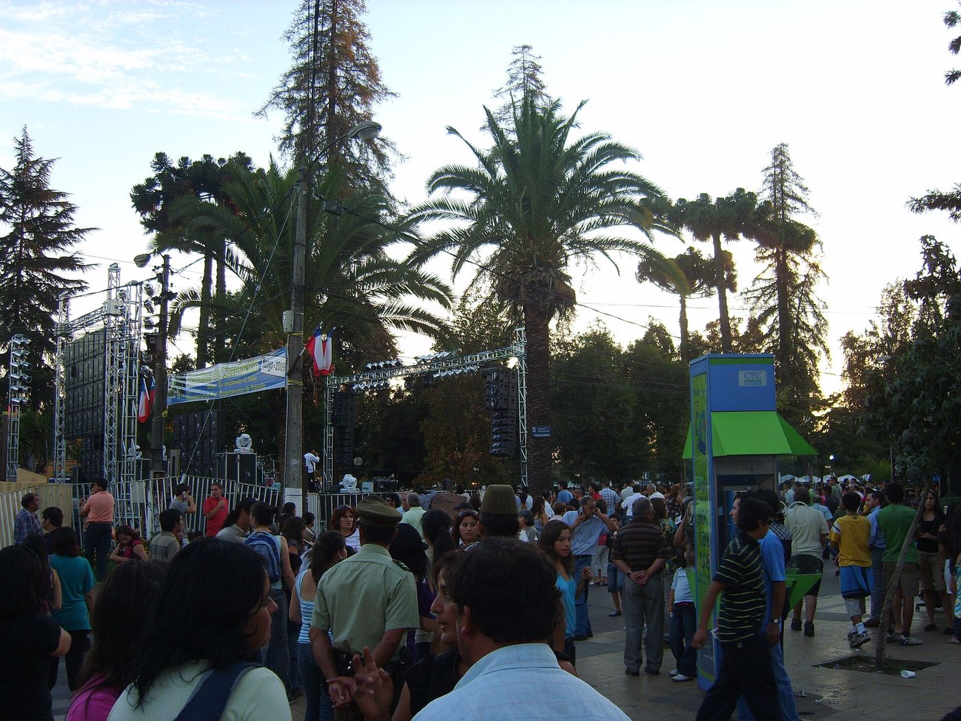 Crowds filling a tree-lined plaza at a Chilean wine harvest festival
