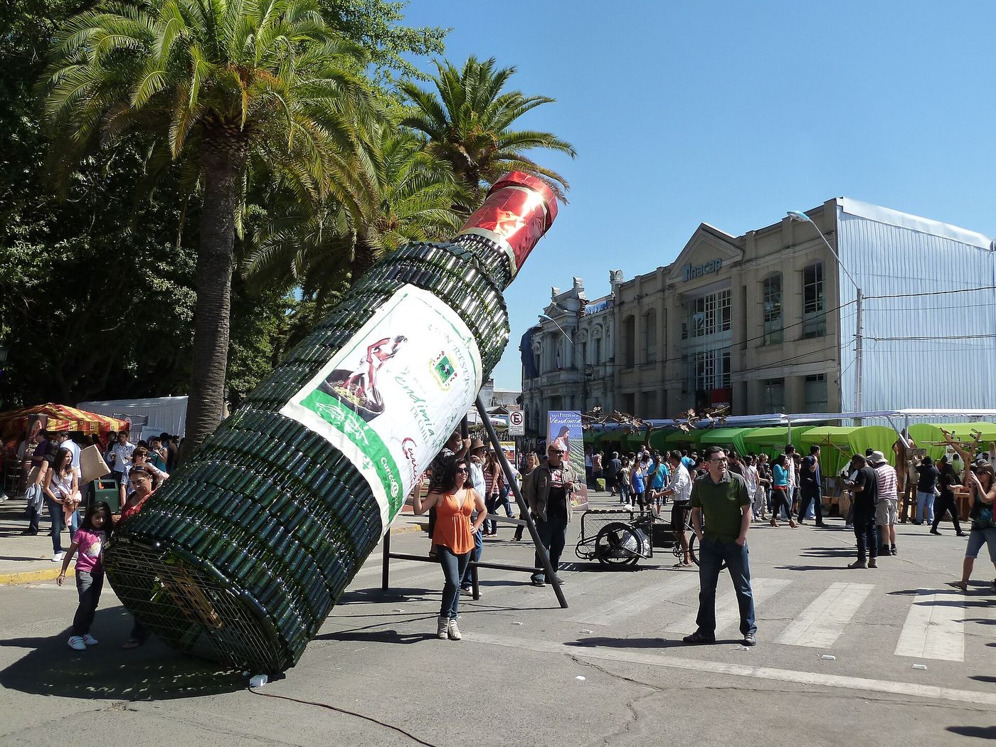 A giant inflatable wine bottle lying across a street during a Chilean harvest festival