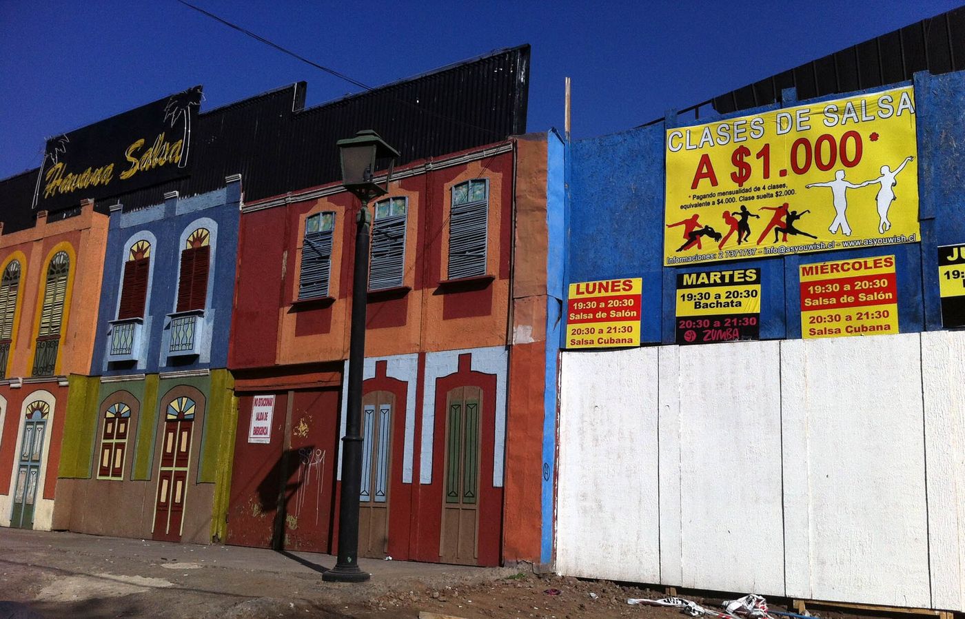 Brightly painted orange, blue and red house fronts on a street in Barrio Bellavista