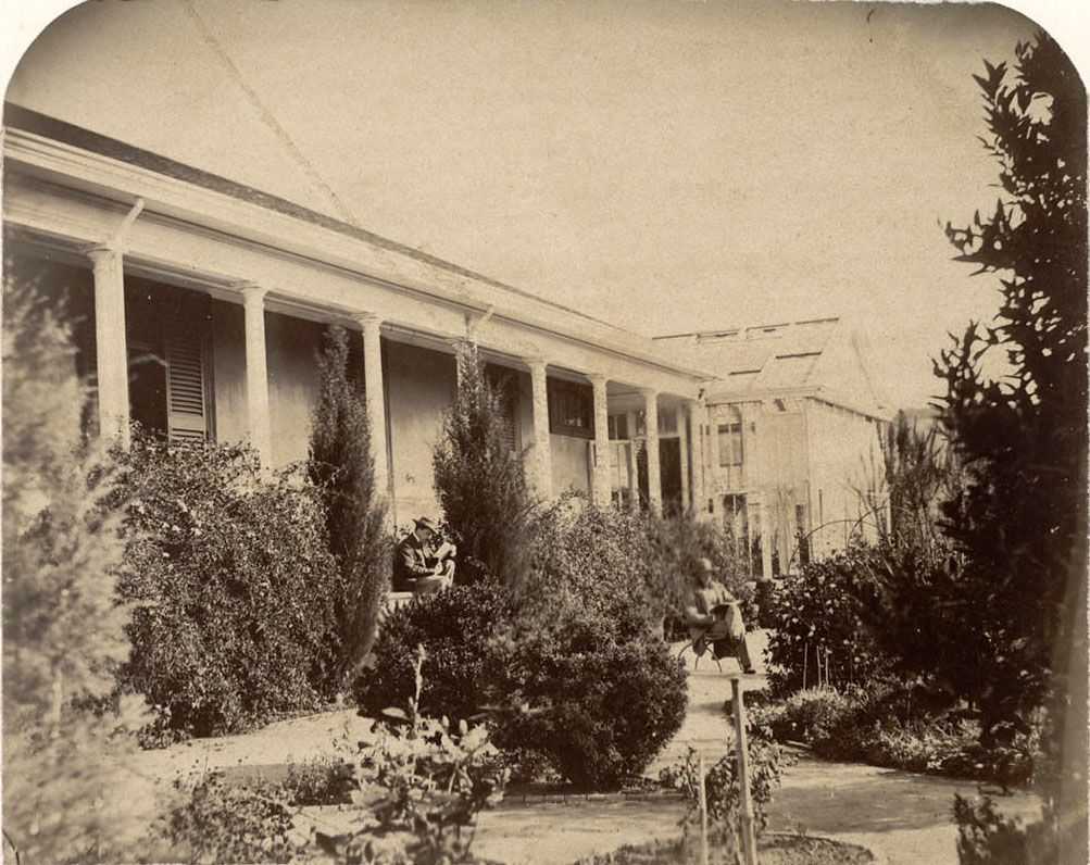 Sepia photograph from 1861 of a long verandaed house and garden on Cerro Alegre