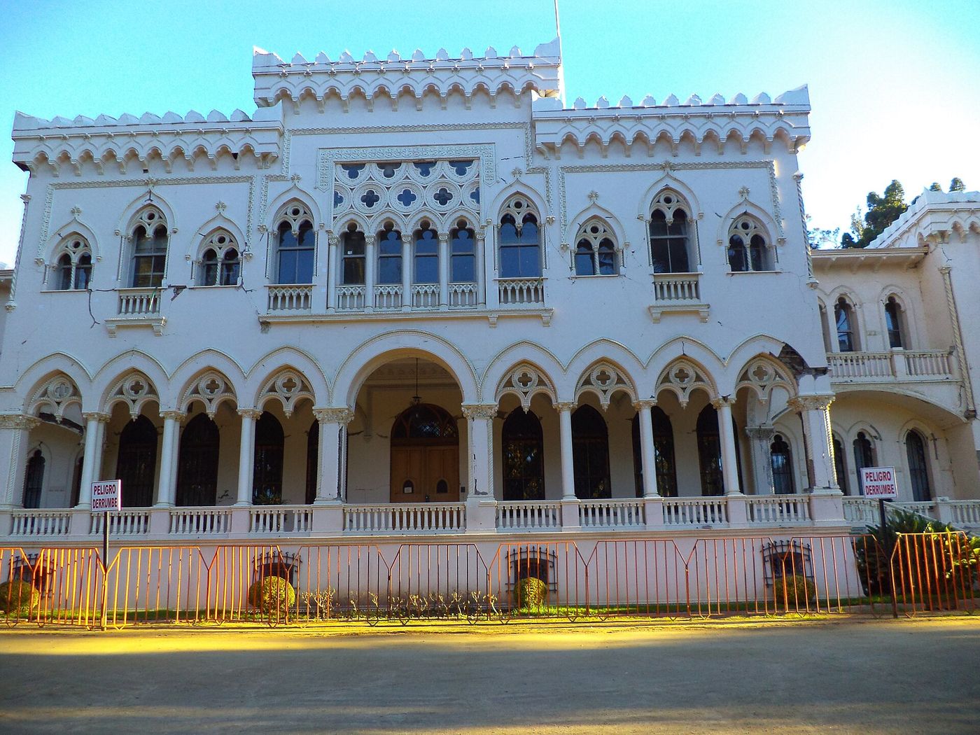 The white Venetian Gothic facade of the Palacio Vergara with arched windows and crenellations