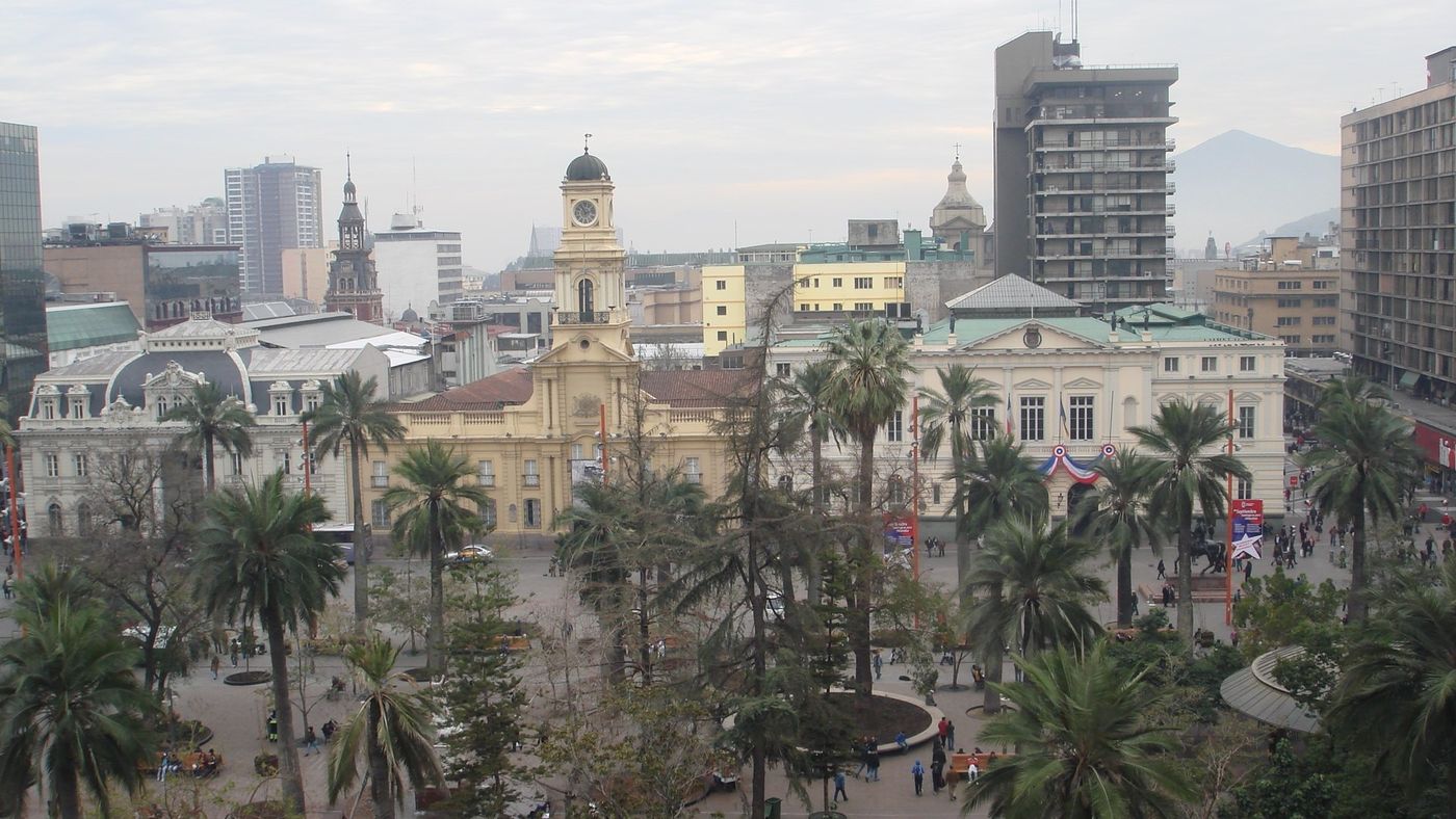 The Plaza de Armas seen from above, with palm trees, the cathedral, the old post office and office towers